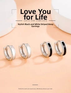 Detail of black and white enamel hoop earrings in s925 silver finish on display