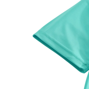 Detail of mint green polo shirt sleeve cuff showing breathable mesh fabric texture