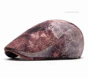 Detail showing vintage tie-dye texture and stitching of this brown newsboy flat cap