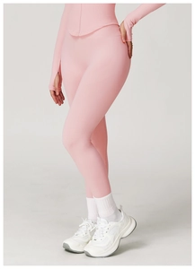 Detailed view of pale pink high-waist yoga pants with seamless ribbed waistband design