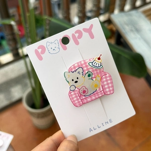 Westie dog acrylic hair clip with pink checkered sofa pattern on display card