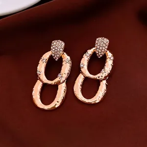 Luxury oval drop earrings with gold hammer texture and sparkling zircon accents