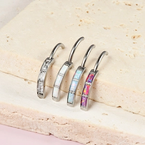 Set of four stainless steel belly rings with oval opals in white, blue and pink colors