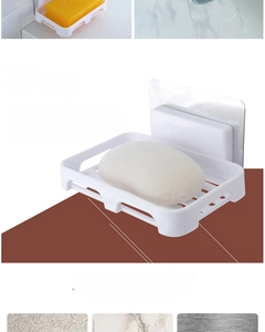 Detail of wall-mounted soap dish with drainage holes and strong adhesive back for tiles