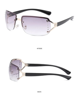 Detail view of rimless fashion sunglasses with purple gradient lenses and rhinestone accents