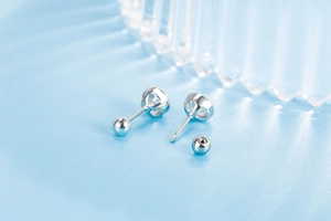Close-up of zircon screw back stud earrings showing the secure threaded closure design