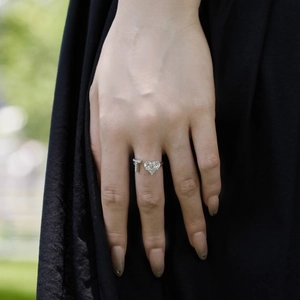 Detailed view of S925 sterling silver ring with heart zircon and letter T charm