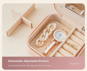 Pink portable jewelry box detail showing adjustable dividers for hair clips and watches