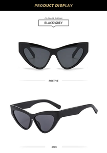 Front and side view of trendy black cat eye sunglasses with dark grey lenses in studio shot