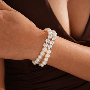 Detail of double-layer faux pearl bracelet with sparkling rhinestone-set components