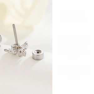 Close-up of titanium steel angel wing cartilage stud with threaded screw-back design