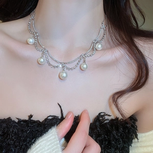 Close-up of elegant double-layered pearl and rhinestone necklace on a model