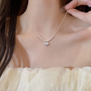 Minimalist silver heart necklace featuring bead accents on a delicate chain for women