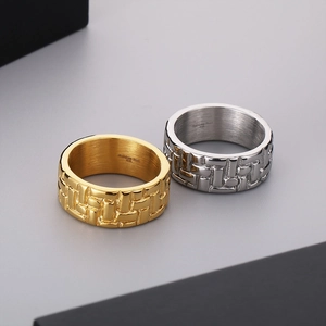 Detailed macro view of 316L stainless steel rings with braided texture in gold and silver