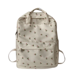 Detailed front view of a beige floral backpack featuring a small pink rose flower pattern
