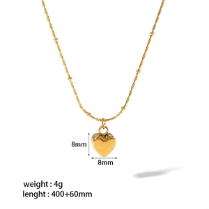 Detail view of 8mm gold heart pendant on bead chain with technical size specifications