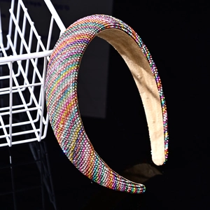 Macro detail of wide headband with colorful rhinestones on a beige fabric lining