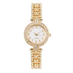 Detailed macro view of gold quartz watch featuring sparkling rhinestone bezel and bead band
