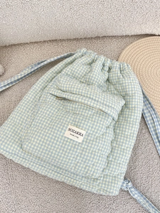 Quilted light blue heart-patterned drawstring backpack with front zip pocket