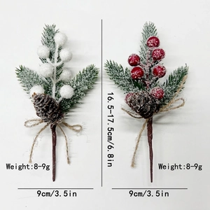Artificial Christmas pine picks with red berries, snow effect, and burlap bow decor