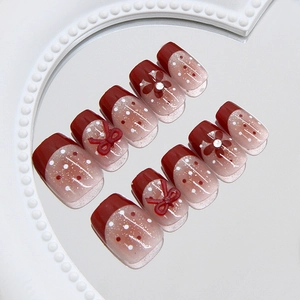 Handmade French cat eye press-on nails with red bows, polka dots and floral accents