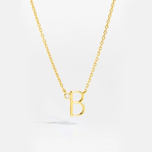 Detail of S925 sterling silver gold letter B pendant necklace with clear gemstone