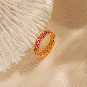 Detailed macro view of 18K gold plated ring with a row of red heart-shaped zircon stones
