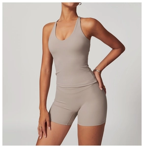 Detail of cross-back yoga vest and high-waisted shorts in matte taupe fabric