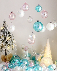 Iridescent Christmas ornament balls set displayed with warm holiday decor and cedar tree