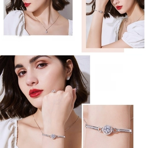 Detail view of silver jewelry set with necklace and bracelet featuring clear round gems