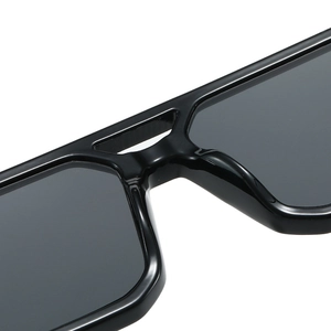 Fashionable double-bridge sunglasses for women featuring glossy black frames and grey lenses