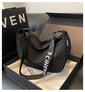Detail of waterproof nylon dumpling bag in gift box with fashion lettered strap