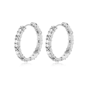 Macro detail of silver hoop earrings featuring a micro-paved crisscross zircon design