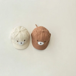 Detail of baby bear ear hats showing soft cotton canvas texture and animal embroidery