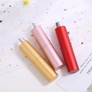 Portable 10ml rotary perfume spray bottles in gold, pink, and red aluminum finish