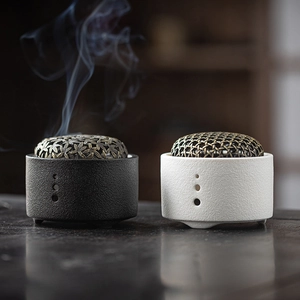 Minimalist black and white ceramic incense burners with metallic hollow carved lids