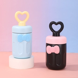 Detail of creative portable straw cups with heart-shaped handles and bow decorations