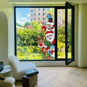 Christmas window decals with Santa Snowman and Reindeer on glass in a modern living room