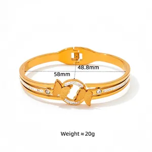 Gold stainless steel butterfly bangle with crystal accents and spring clasp closure