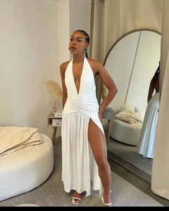 Detail of white deep V-neck halter dress featuring ruched waist and high side slit design