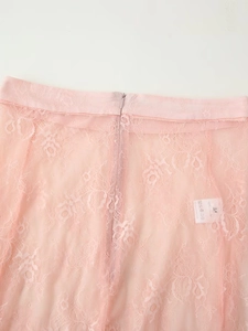 Detail of pink lace skirt showing M size label, polyester fabric and hidden zipper closure