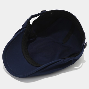 Classic dark blue canvas newsboy cap with metal snap button and sweatband detail
