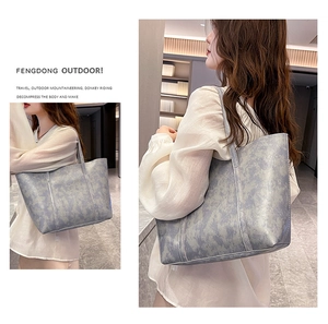 Detail of grey marble pattern tote bag showing high-quality leather texture and large capacity