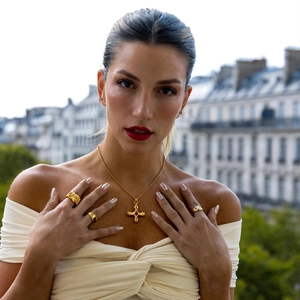 18k gold plated stainless steel cross necklace with tiger eye stone on a female model