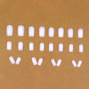 24-piece short squoval press-on nails in milky white and silver glitter finish
