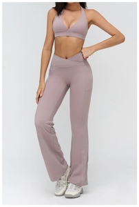 Detail of mauve yoga set with crossover V-waist flared pants and halter sports bra