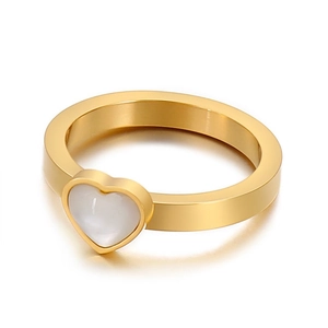 Minimalist gold heart ring featuring a white cat's eye stone on a wide polished band