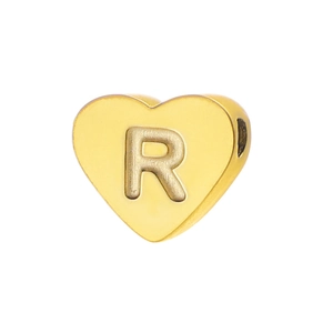 Detailed view of polished golden heart bead with letter R engraving for DIY jewelry