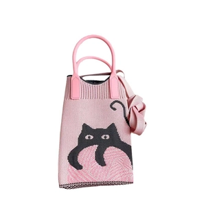 Detailed knit texture of pink cat pattern crossbody phone bag with sturdy top handles