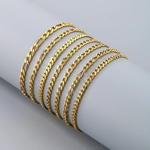 Detailed close-up of multiple golden stainless steel chain styles on a cylindrical mold